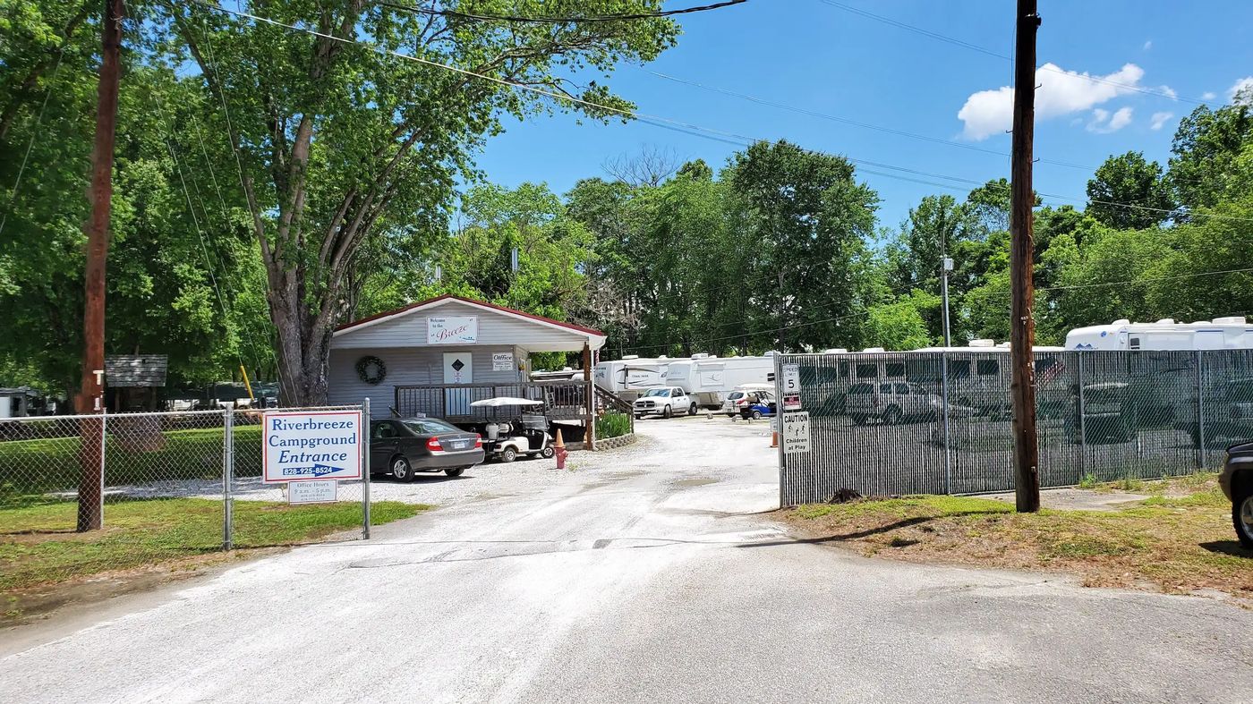The gated entrance to the fenced storage area, with rigs parked inside