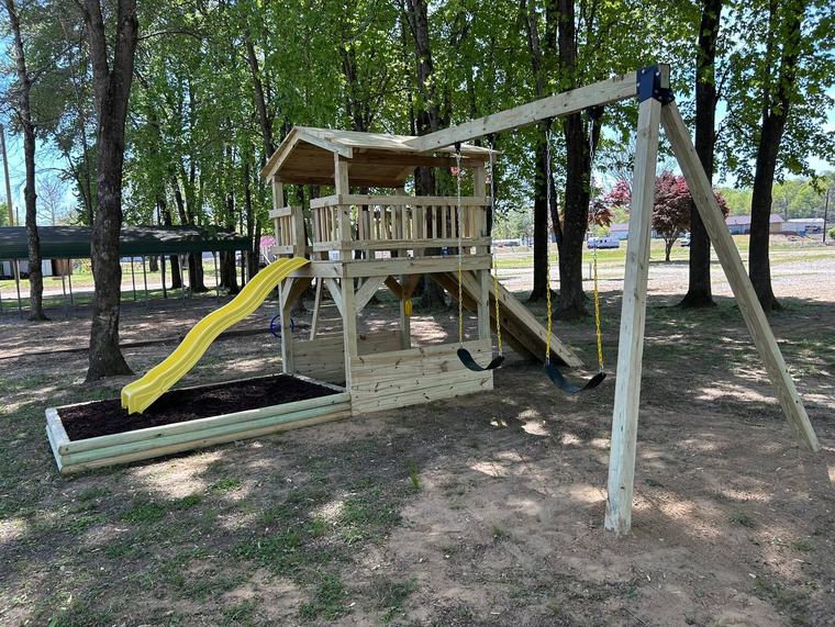 The playground structure with its slide and swings
