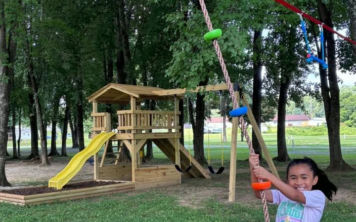 A child riding the zip line at the Riverbreeze playground